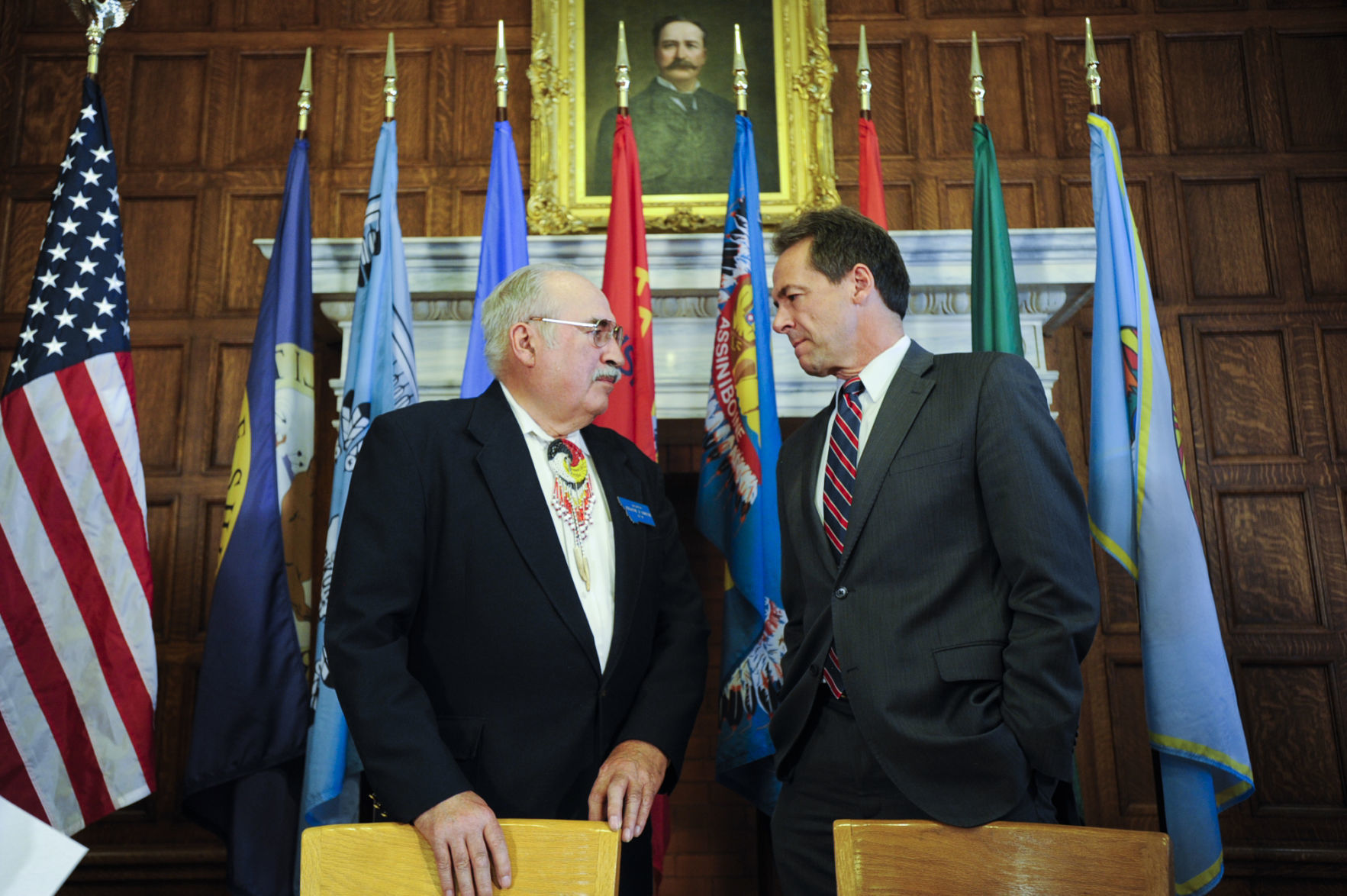 Gov. Steve Bullock, right, talks with Sen. Frank Smith